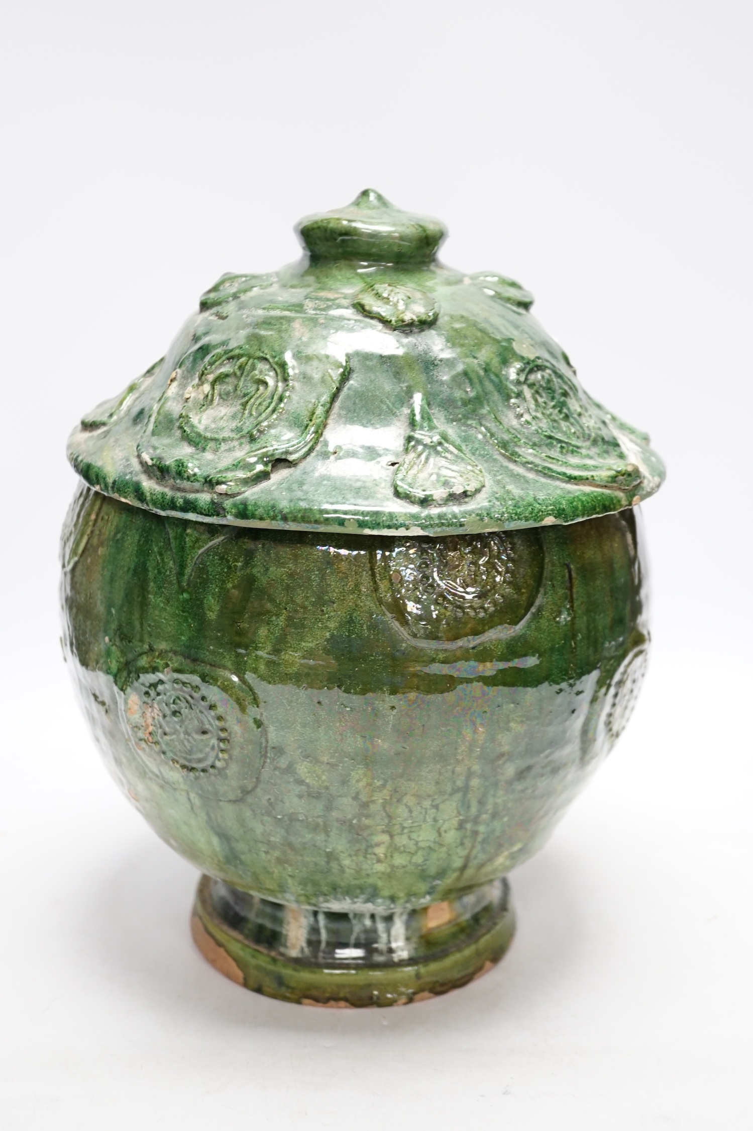 A Chinese Buddhist green glazed jar and cover, Song-Yuan dynasty, 33cm